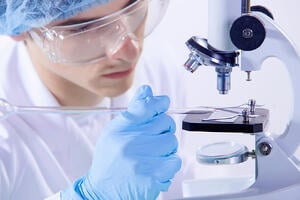 Image of man scientist working in laboratory with microscope-1